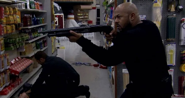 Alien Raiders 2008 Movie Scene Rockmond Dunbar as Kane holding a shotgun inside the supermarket