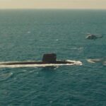 The Wolfs Call 2019 Movie Scene The submarine surfacing with the helicopter hovering over it