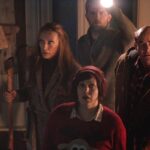 Krampus 2015 Movie Scene Toni Collette as Sarah holding an axe along with Adam Scott as Tom, David Koechner as Howard and Allison Tolman as Linda going to the attic to see what's making the noise