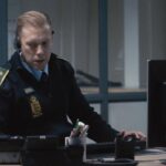The Guilty 2018 Movie Scene Jakob Cedergren as Asger Holm as an emergency services operator talking to a kidnapped woman