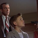 The Man Who Knew Too Much 1956 Movie Scene James Stewart as Dr. Benjamin McKenna and Christopher Olsen as Hank kidnapped at gunpoint
