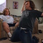 Tenacious D in The Pick of Destiny 2006 Movie Scene Jack Black as JB practicing a power slide under Kyle Gass as KG instructions