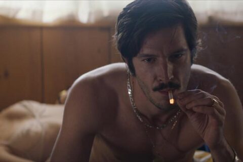 Dusk For A Hitman 2023 Movie Scene Éric Bruneau as Donald Lavoie smoking in bed after sex